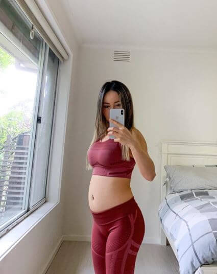 Adrian's girlfriend, Chloe Ting with a bloated stomach. 